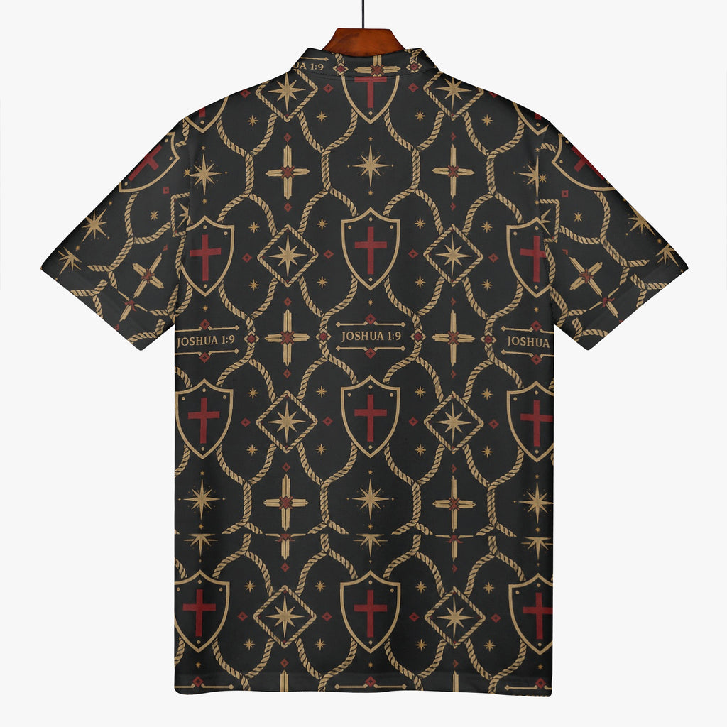SANCTUS NOVA polo in the signature monogram on a hanger — gold trellis, shields and oxblood crosses on charcoal