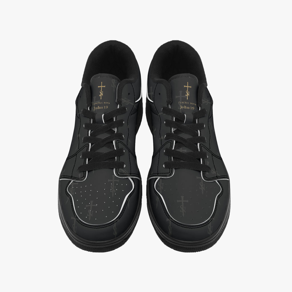 Front view of SANCTUS NOVA Deep Black sneakers with complete gold-color signatures and Joshua 1:9 above the laces.