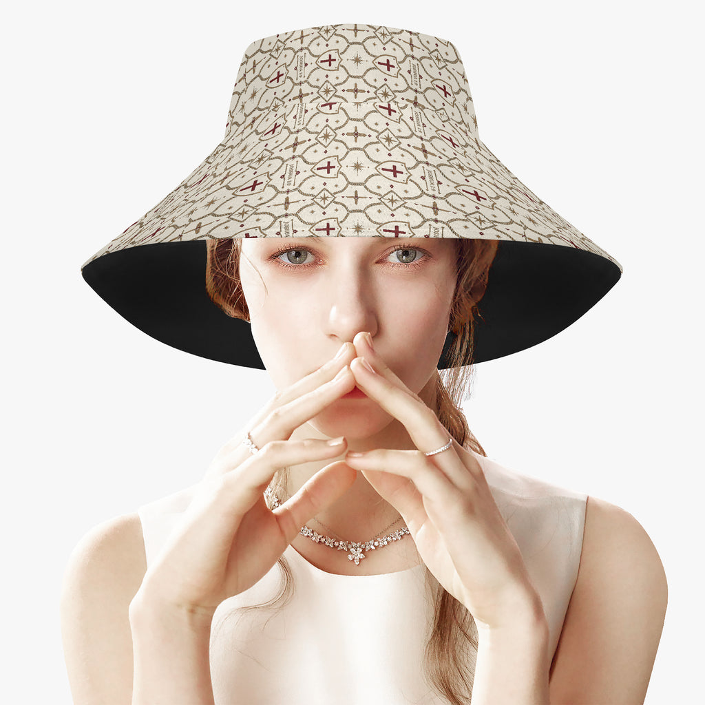 CARRY THE STANDARD bucket hat in ivory, SANCTUS NOVA house monogram across crown and brim